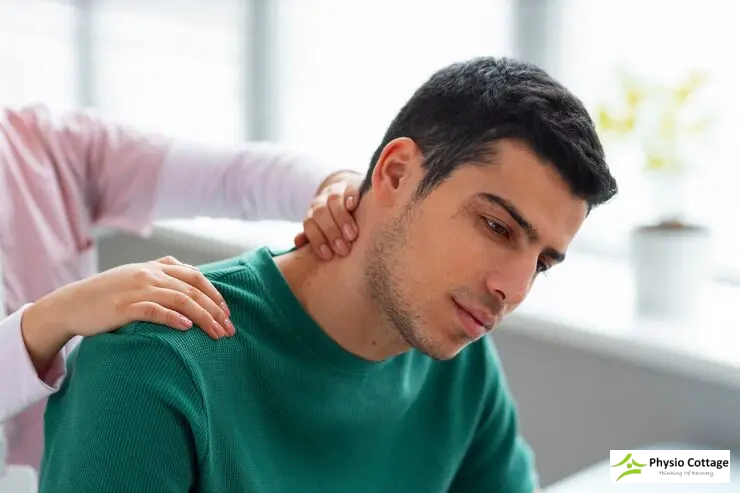 A professional gently applies a soothing touch to the neck of a male patient.