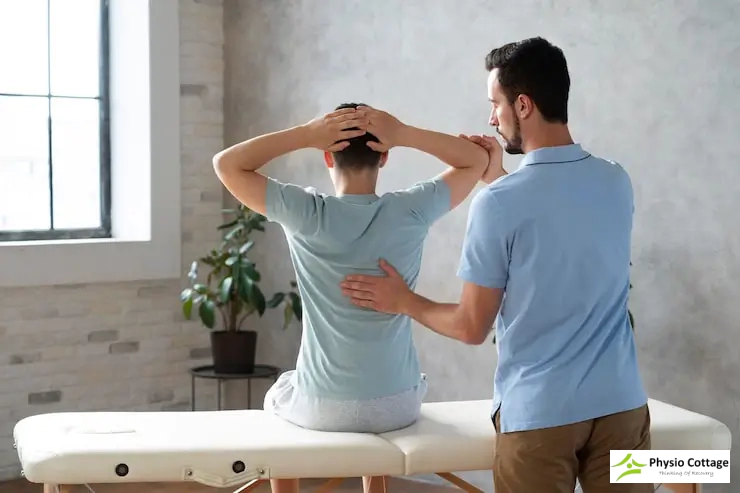 A physiotherapist assists a patient with a therapeutic exercise.