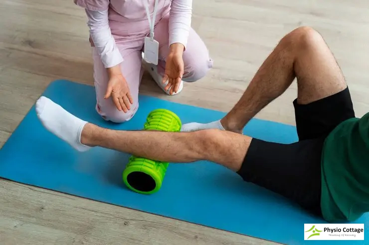 A close-up view of a person's leg resting on a blue exercise mat.
