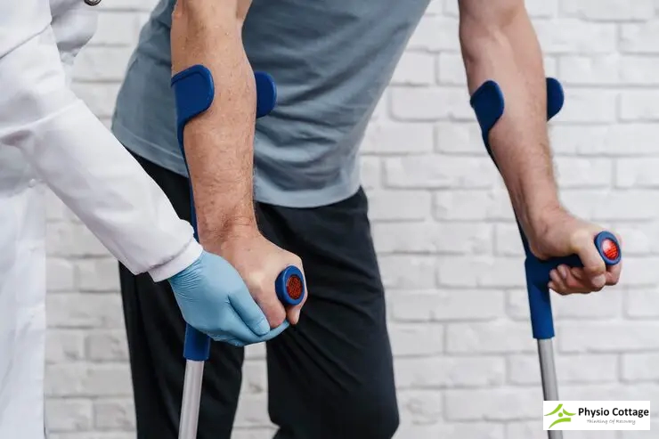 Close-up of a person's hands wearing medical gloves assisting a patient's.
